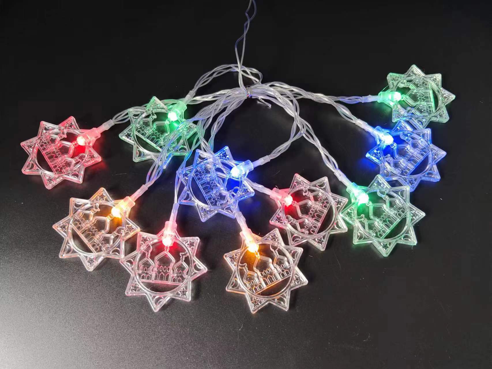 String lights with star-shaped bulbs on a black background