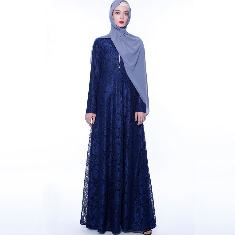 Woman wearing a navy blue lace dress with a matching hijab on a white background