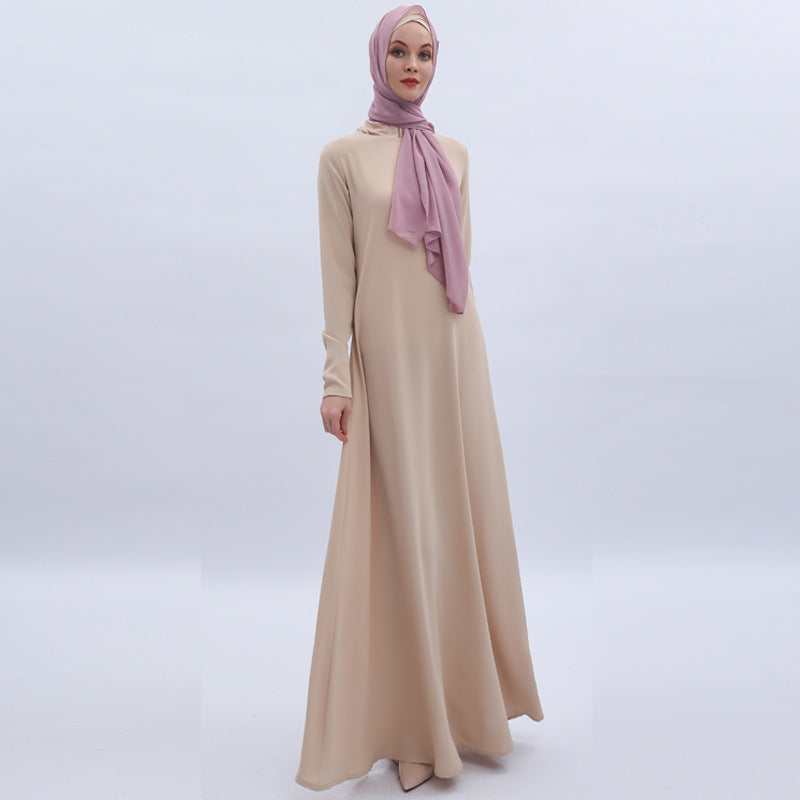 Beige long dress with a pink hijab on a white background