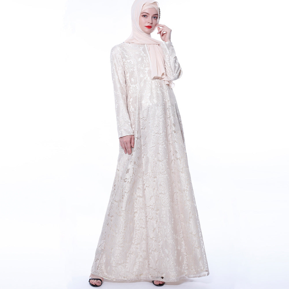 Woman wearing a long, light-colored dress with a matching hijab on a white background