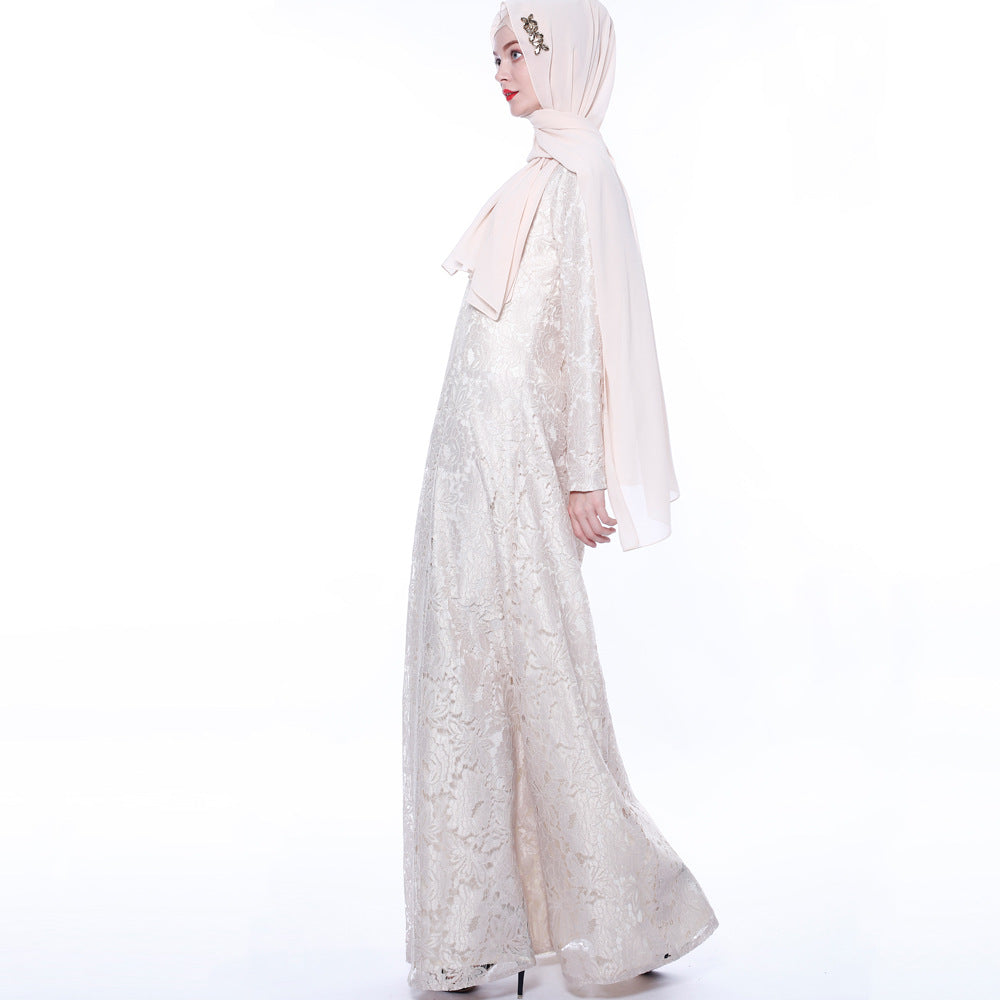 Woman wearing a long, light-colored dress with a matching hijab on a white background