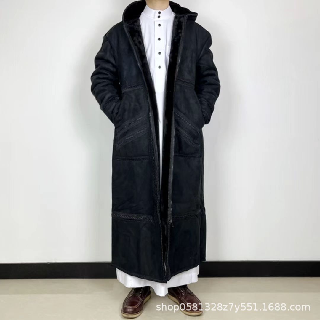 Long black coat worn by a person on a white background
