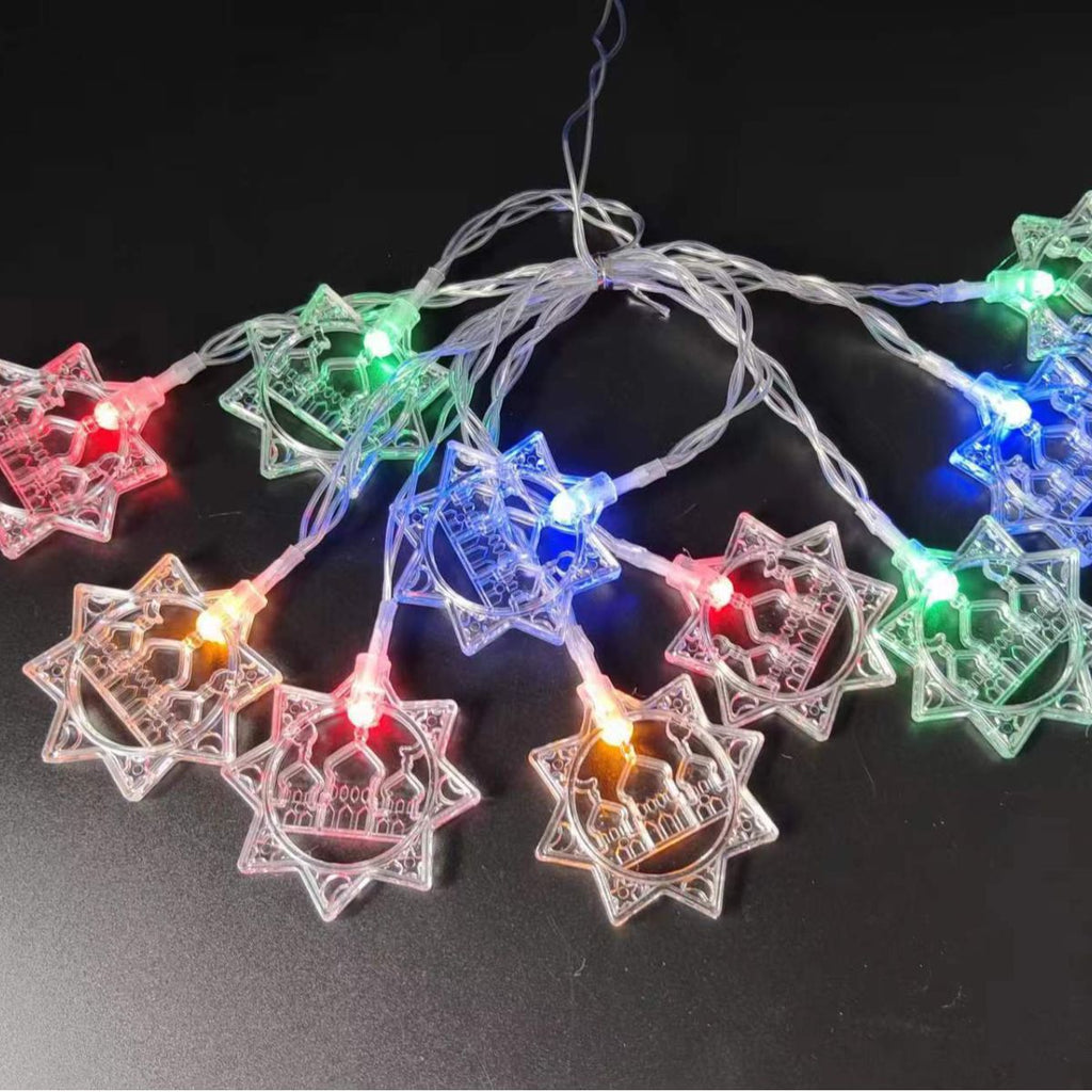 Decorative string lights shaped like stars on a black background
