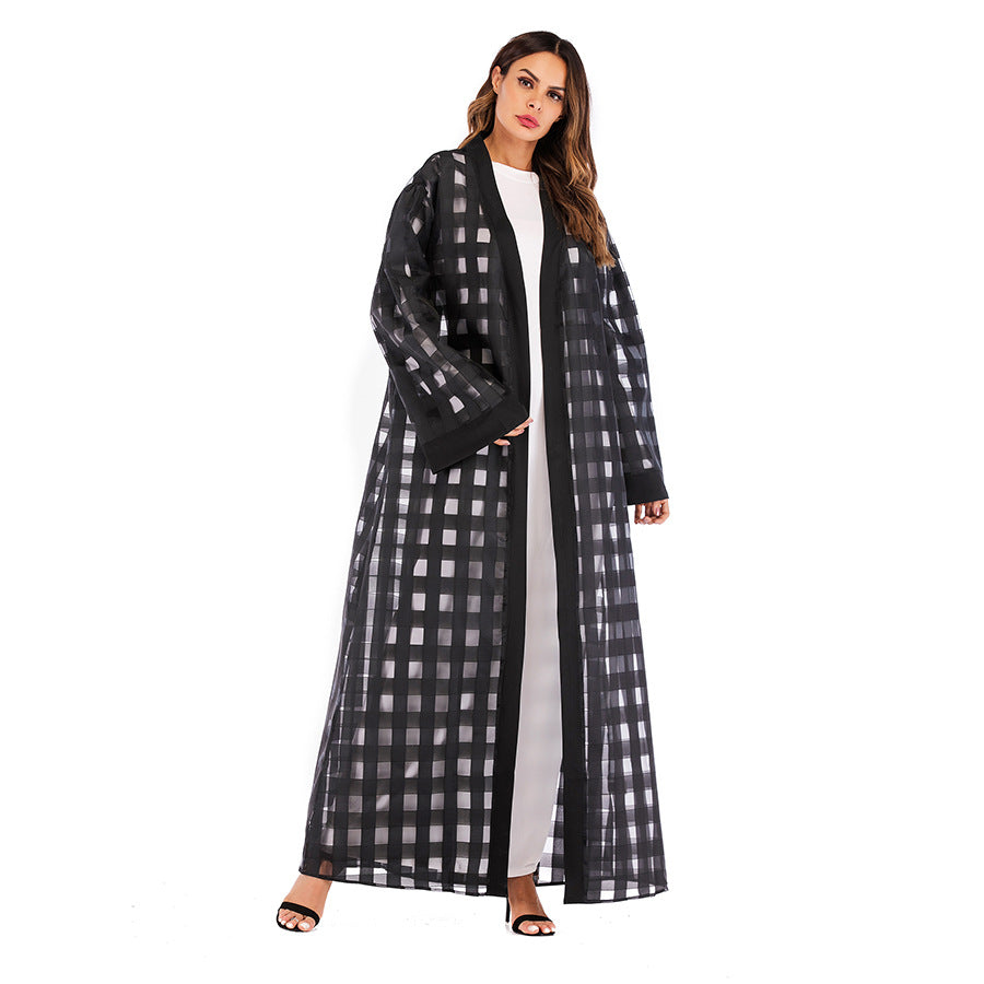 Woman wearing a black and white checkered coat on a white background
