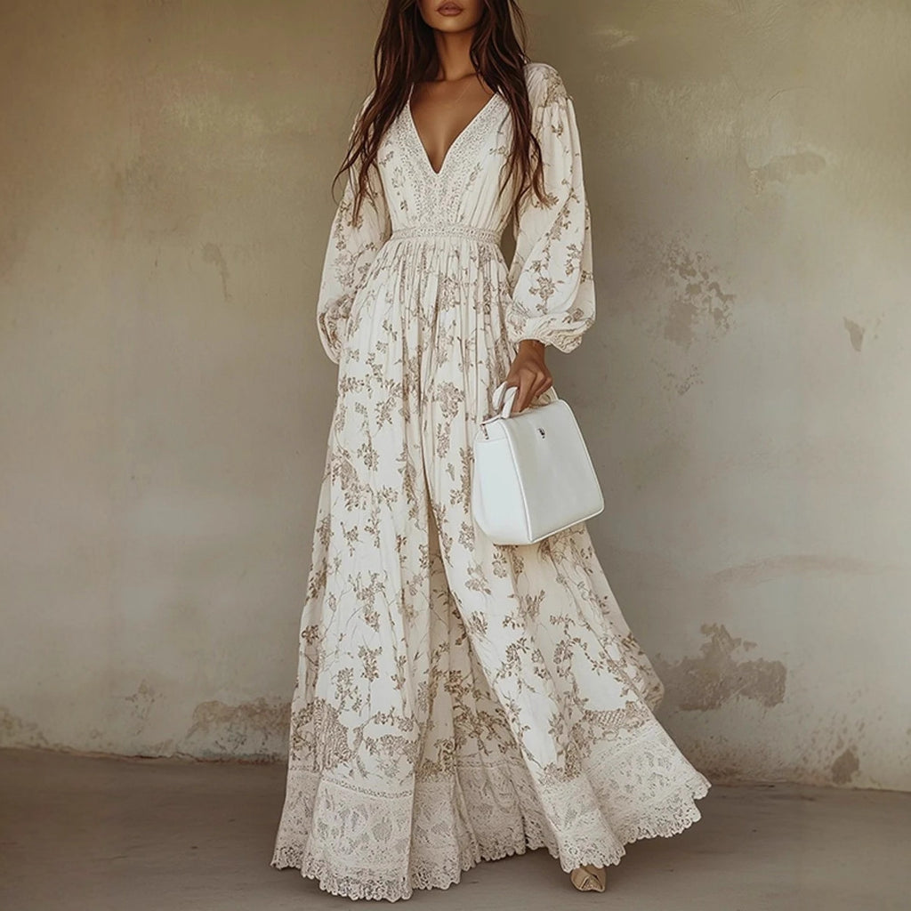 Woman wearing a long floral dress holding a white handbag against a textured wall.