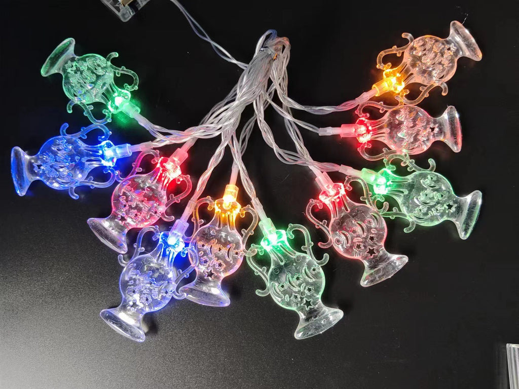 String lights with colorful jellyfish-shaped bulbs on a black background