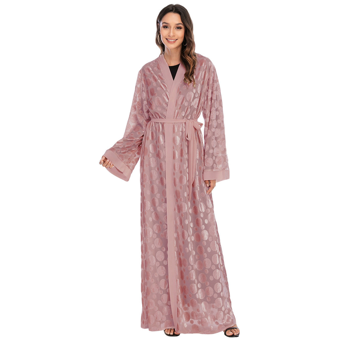 Woman wearing a pink patterned robe on a white background